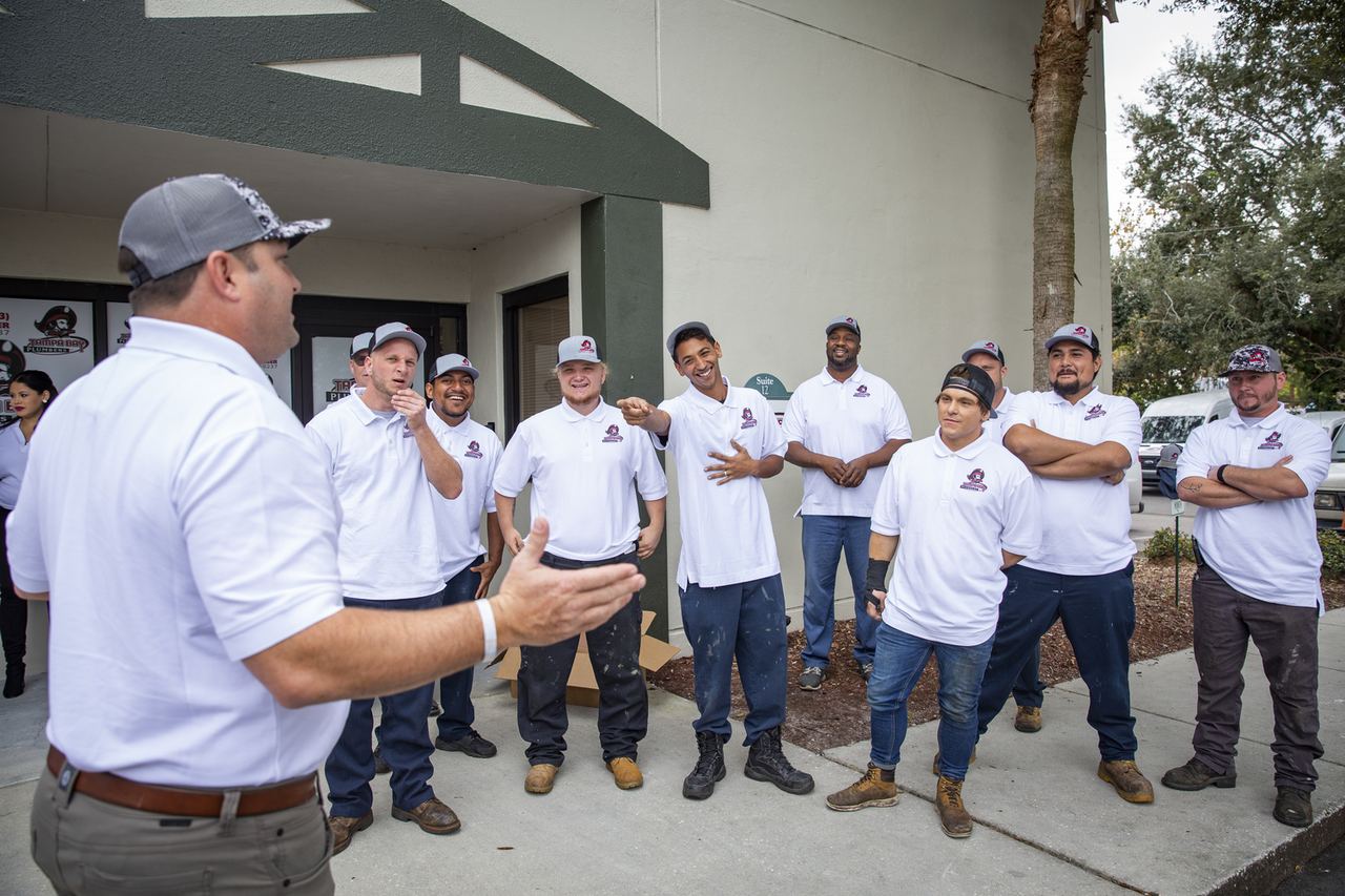 The Tampa Bay Plumbers crew gathered outside the shop for a morning briefing